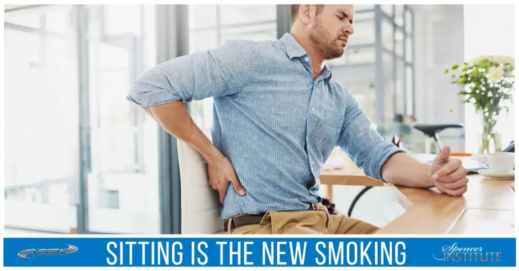 man sitting at desk with back pain